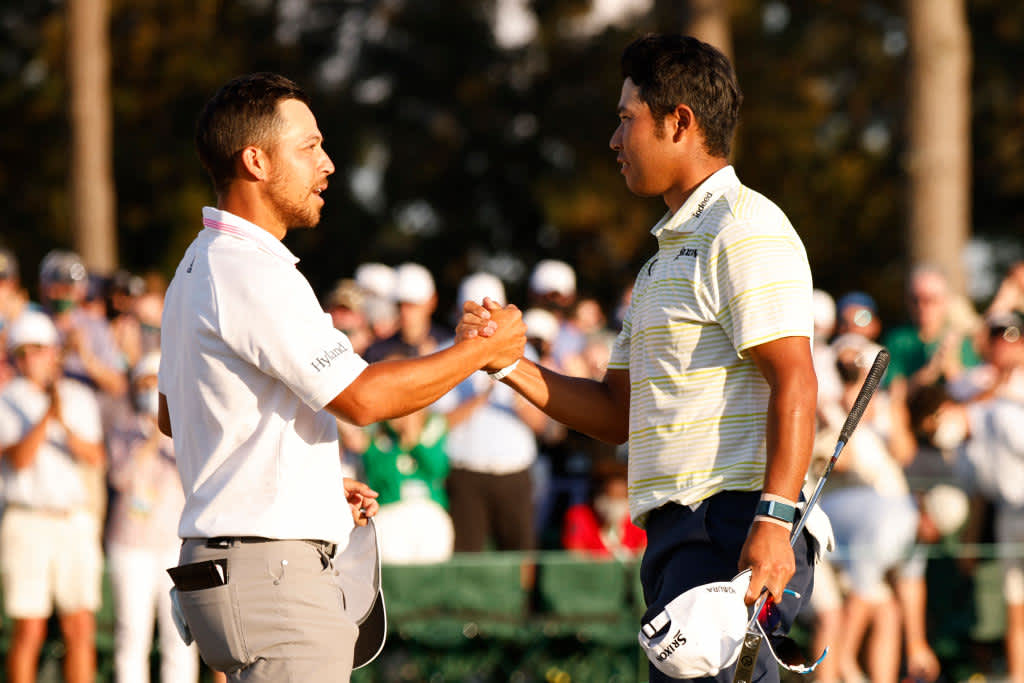 AUGUSTA, GEORGIA - APRIL 11: Hideki Matsuyama of Japan shakes hands with Xander Schauffele of the United States on the 18th green after winning the Masters at Augusta National Golf Club on April 11, 2021 in Augusta, Georgia. (Photo by Jared C. Tilton/Getty Images)