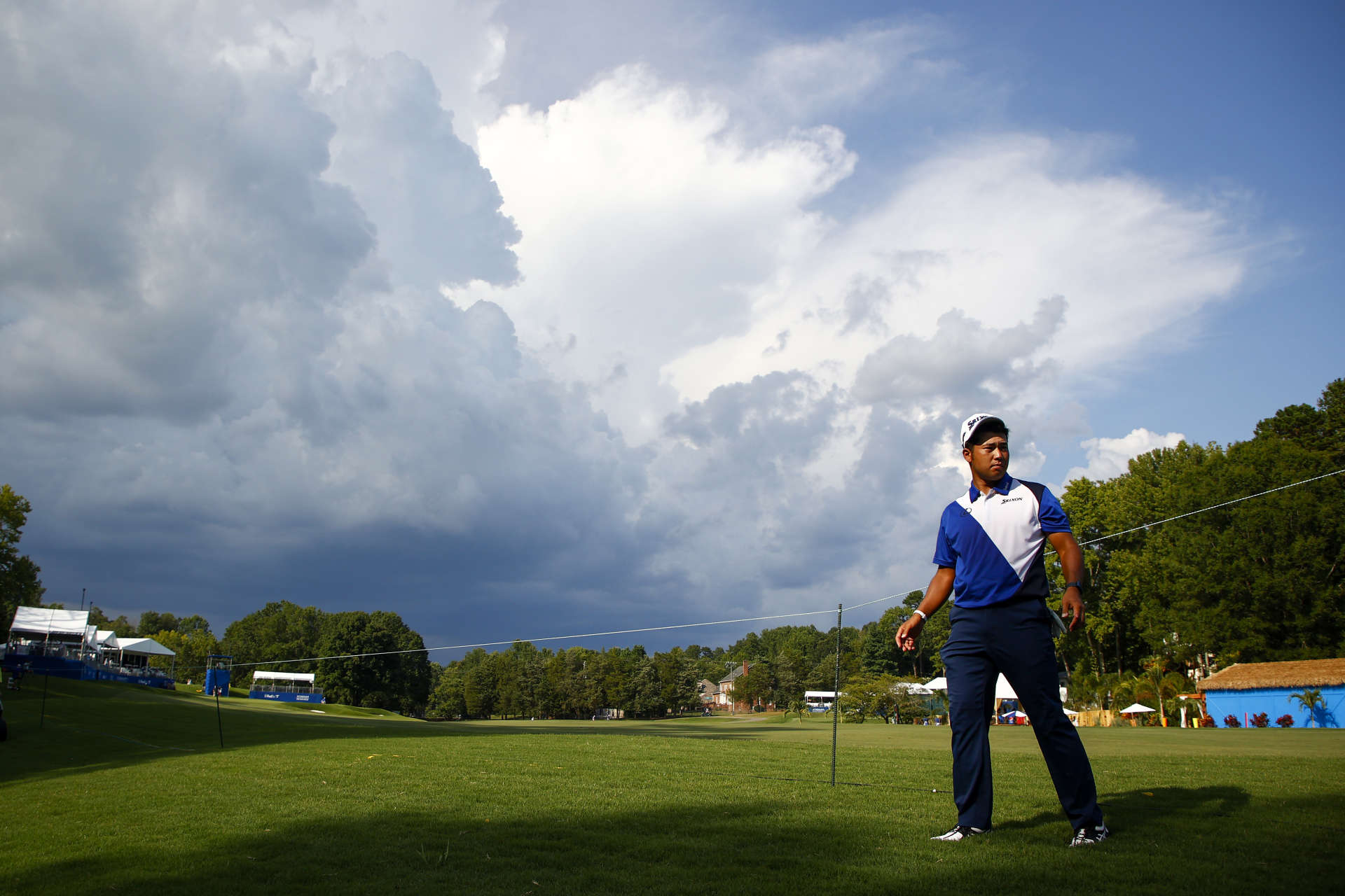 GREENSBORO, NORTH CAROLINA - AUGUST 12: Hideki Matsuyama of Japan walks off the 15th hole due to inclement weather during the first round of the Wyndham Championship at Sedgefield Country Club on August 12, 2021 in Greensboro, North Carolina. (Photo by Jared C. Tilton/Getty Images)