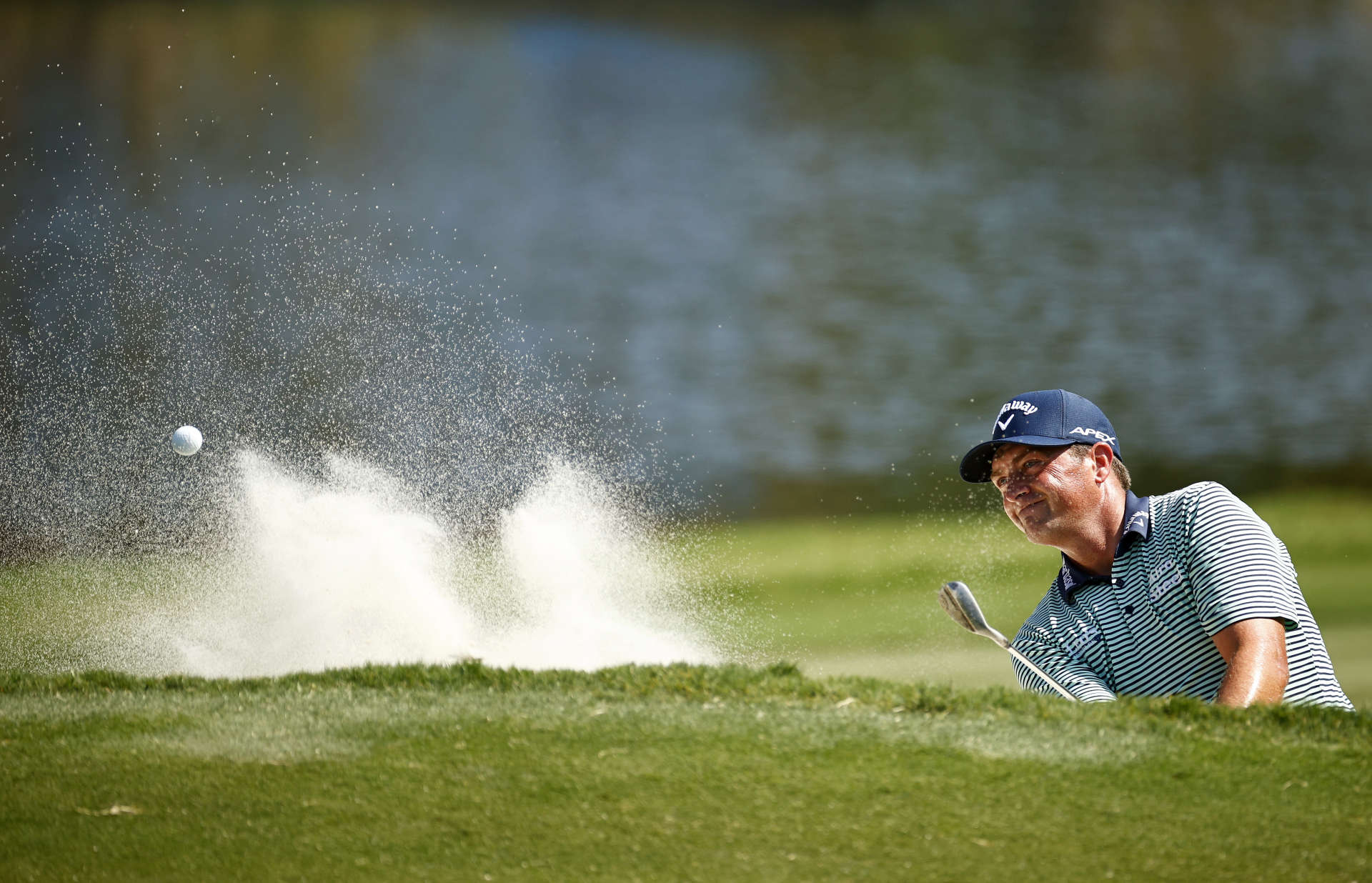 GREENSBORO, NORTH CAROLINA - AUGUST 13: Brian Stuard of the United States plays his second shot from a greenside bunker on the 15th hole to hole out during the second round of the Wyndham Championship at Sedgefield Country Club on August 13, 2021 in Greensboro, North Carolina. (Photo by Jared C. Tilton/Getty Images)