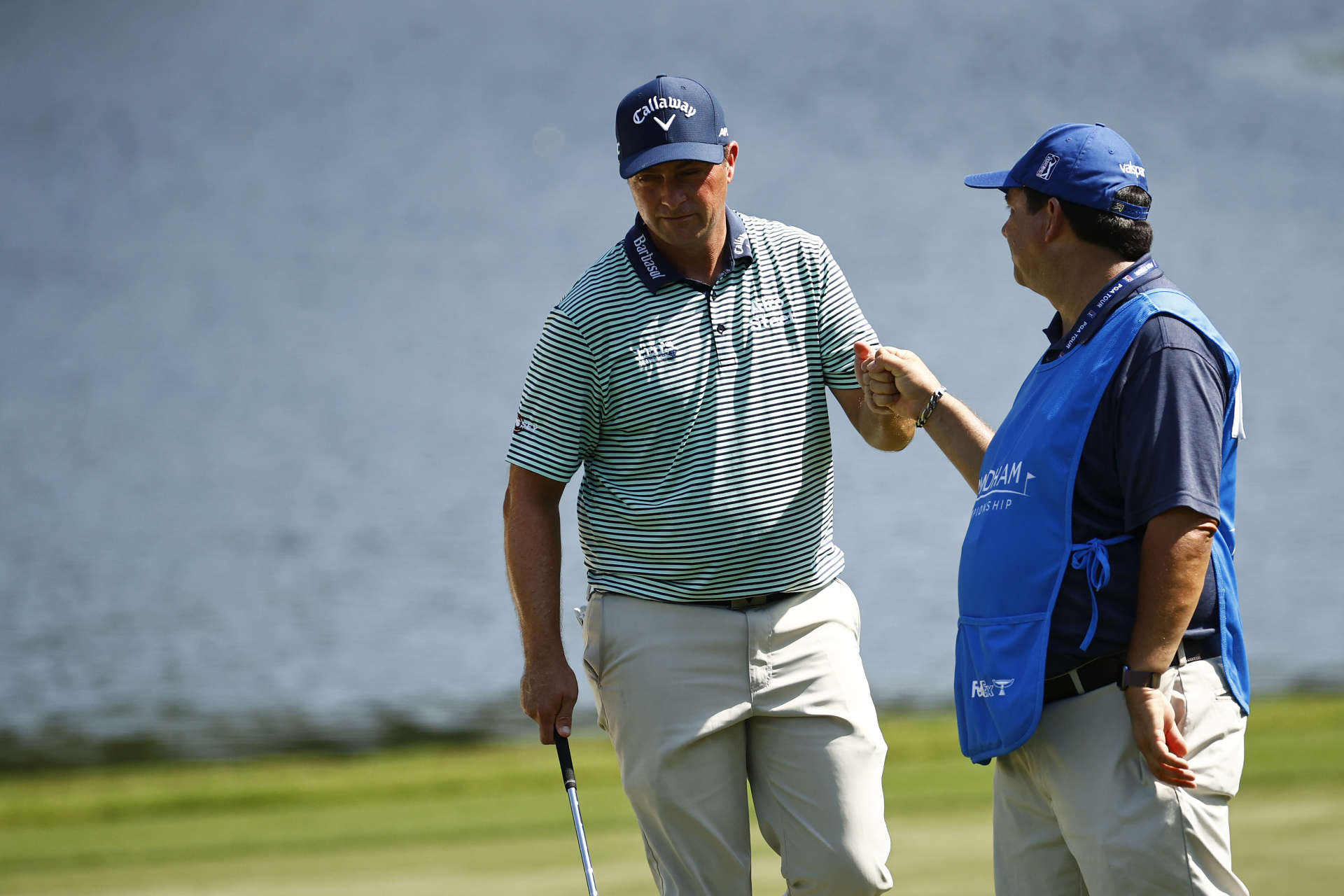 GREENSBORO, NORTH CAROLINA - AUGUST 13: Brian Stuard of the United States fist bumps his caddie after a bunker shot on the 15th hole during the second round of the Wyndham Championship at Sedgefield Country Club on August 13, 2021 in Greensboro, North Carolina. (Photo by Jared C. Tilton/Getty Images)