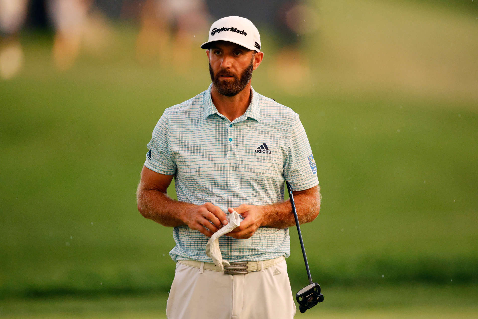 OWINGS MILLS, MARYLAND - AUGUST 27: Dustin Johnson of the United States checks his yardage book on the 18th green during the second round of the BMW Championship at Caves Valley Golf Club on August 27, 2021 in Owings Mills, Maryland. (Photo by Tim Nwachukwu/Getty Images)