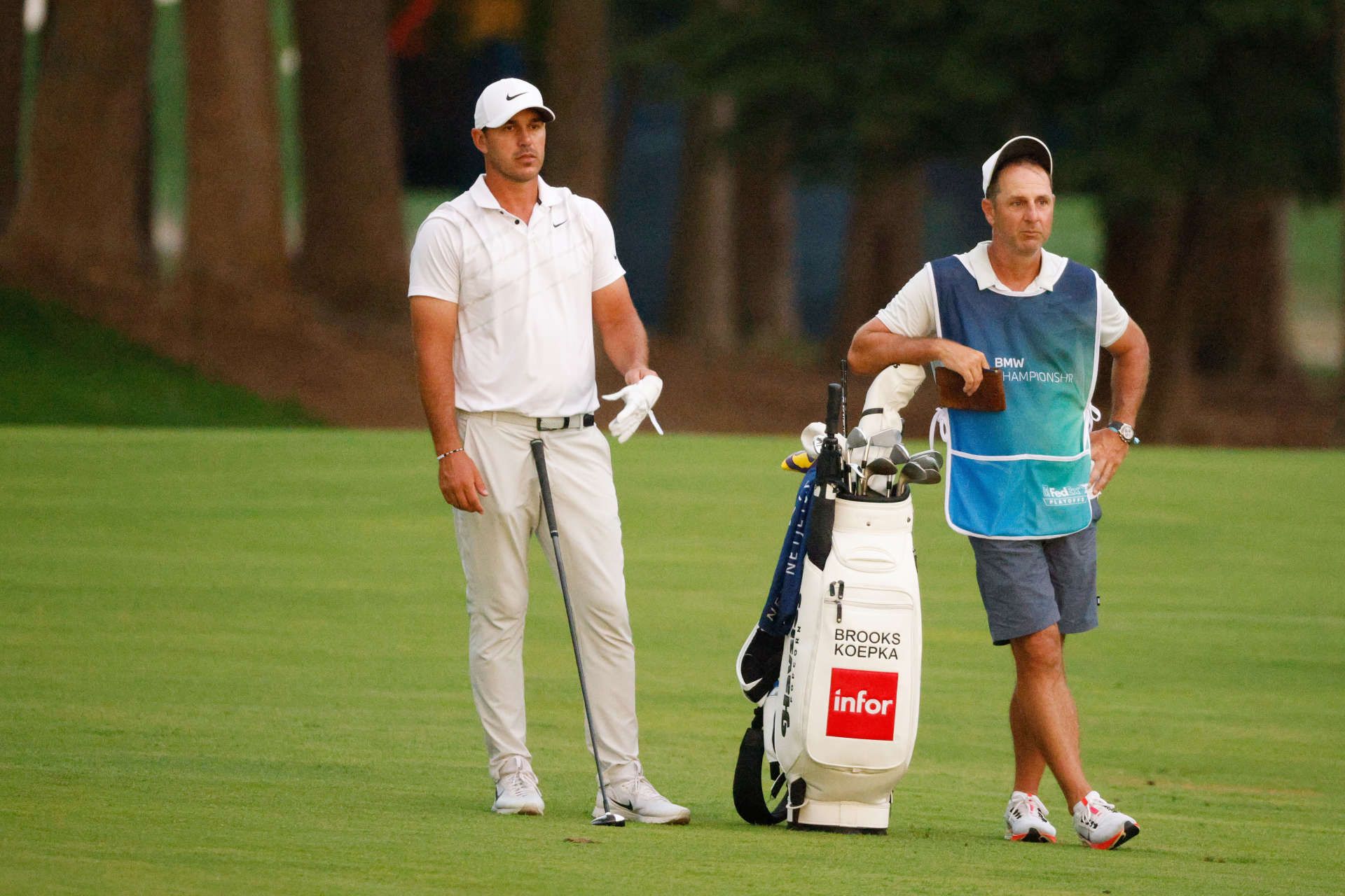 OWINGS MILLS, MARYLAND - AUGUST 27: Brooks Koepka of the United States and caddie Ricky Elliott wait to play on the 16th hole during the second round of the BMW Championship at Caves Valley Golf Club on August 27, 2021 in Owings Mills, Maryland. (Photo by Cliff Hawkins/Getty Images)