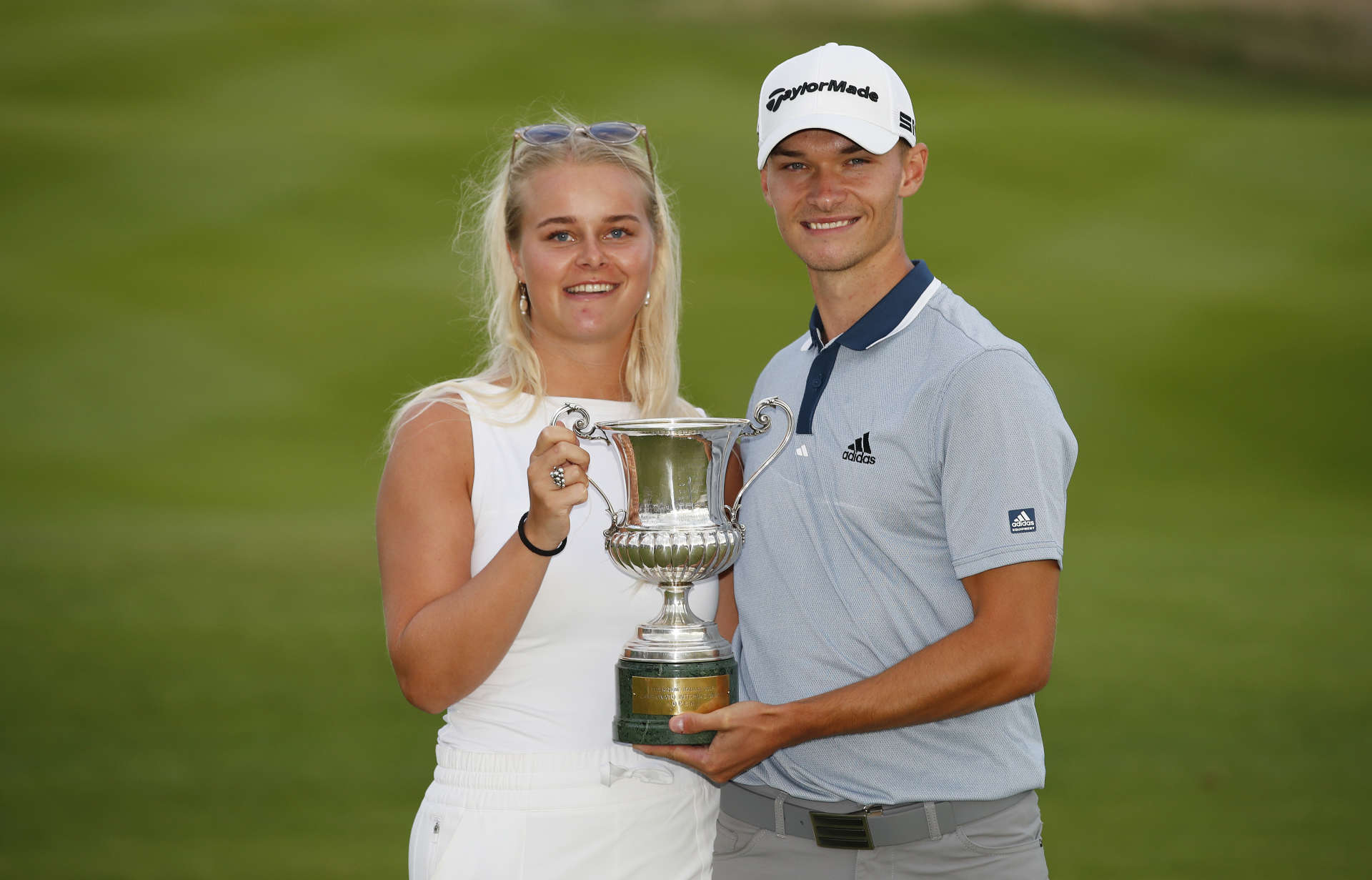 ROME, ITALY - SEPTEMBER 05: Nicolai Hojgaard of Denmark poses for a photo with his girlfriend and the trophy during Day Four of The Italian Open at Marco Simone Golf Club on September 05, 2021 in Rome, Italy. (Photo by Luke Walker/Getty Images)