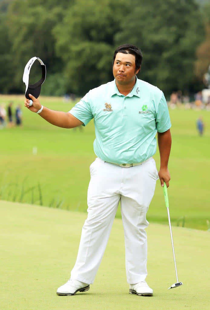 VIRGINIA WATER, ENGLAND - SEPTEMBER 12: Kiradech Aphibarnrat of Thailand takes a bow to the crowd on the 18th green after his round during Day Four of The BMW PGA Championship at Wentworth Golf Club on September 12, 2021 in Virginia Water, England. (Photo by Andrew Redington/Getty Images)