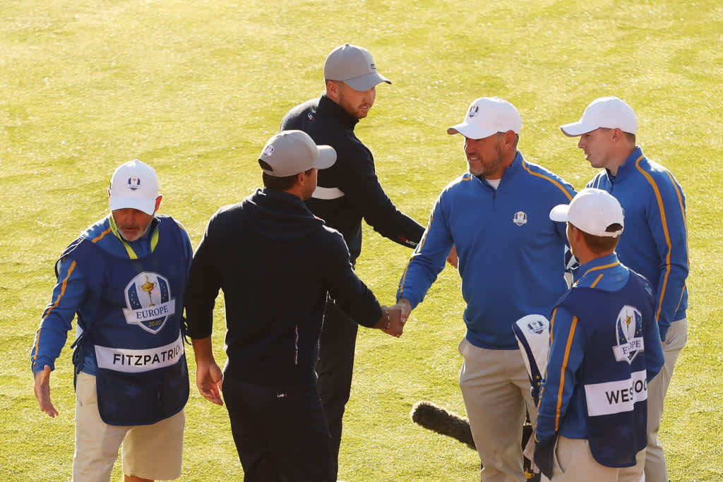 KOHLER, WISCONSIN - SEPTEMBER 24: (L-R) Brooks Koepka of team United States, Daniel Berger of team United States, Lee Westwood of England and team Europe, and Matthew Fitzpatrick of England and team Europe shake hands on the first tee during Friday Morning Foursome Matches of the 43rd Ryder Cup at Whistling Straits on September 24, 2021 in Kohler, Wisconsin. (Photo by Warren Little/Getty Images)