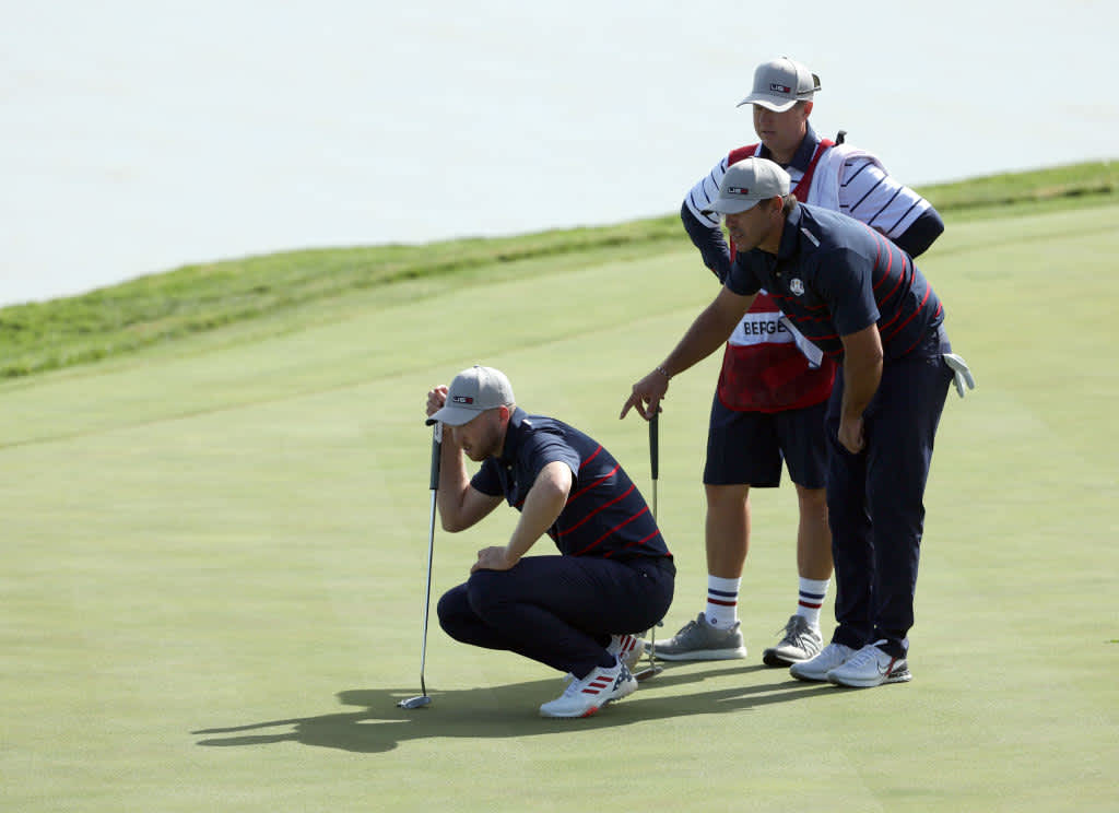 KOHLER, WISCONSIN - SEPTEMBER 24: Daniel Berger of team United States (L) and Brooks Koepka of team United States line up a putt on the 17th green during Friday Morning Foursome Matches of the 43rd Ryder Cup at Whistling Straits on September 24, 2021 in Kohler, Wisconsin. (Photo by Patrick Smith/Getty Images)