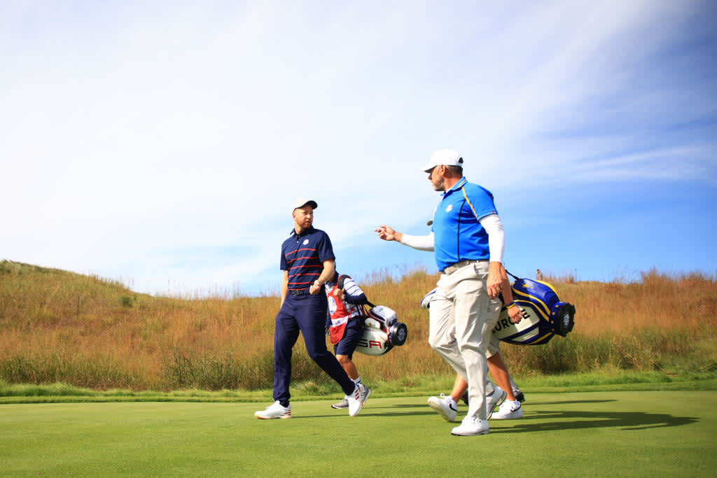 KOHLER, WISCONSIN - SEPTEMBER 24: Daniel Berger of team United States (L) and Lee Westwood of England and team Europe walk off the 15th tee during Friday Morning Foursome Matches of the 43rd Ryder Cup at Whistling Straits on September 24, 2021 in Kohler, Wisconsin. (Photo by Mike Ehrmann/Getty Images)
