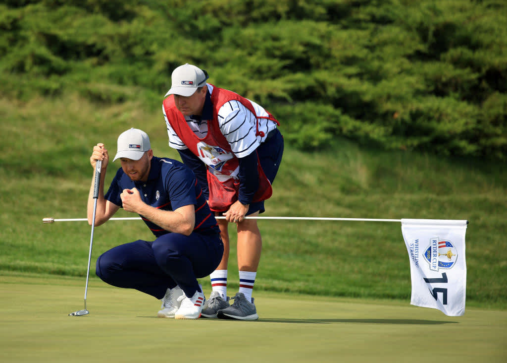 KOHLER, WISCONSIN - SEPTEMBER 24: Daniel Berger of team United States and his caddie Josh Cassell line up a putt on the 15th green during Friday Morning Foursome Matches of the 43rd Ryder Cup at Whistling Straits on September 24, 2021 in Kohler, Wisconsin. (Photo by Mike Ehrmann/Getty Images)