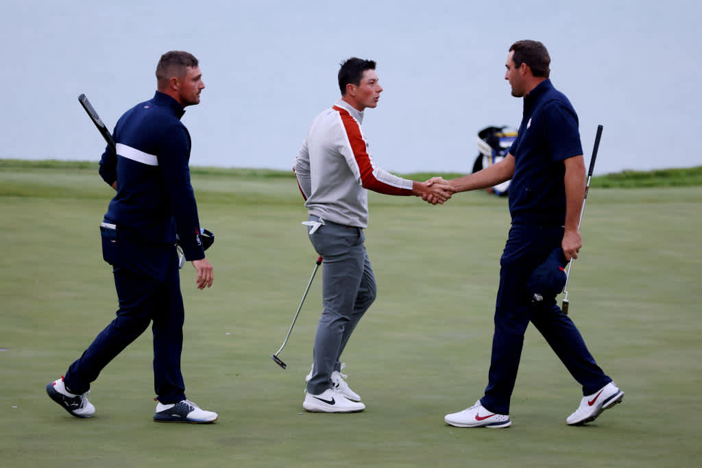 KOHLER, WISCONSIN - SEPTEMBER 25: Scottie Scheffler of team United States and Bryson DeChambeau of team United States shake hands with Tommy Fleetwood (not pictured) of England and team Europe and Viktor Hovland of Norway and team Europe after defeating them 3&1 during Saturday Morning Foursome Matches of the 43rd Ryder Cup at Whistling Straits on September 25, 2021 in Kohler, Wisconsin. (Photo by Richard Heathcote/Getty Images)