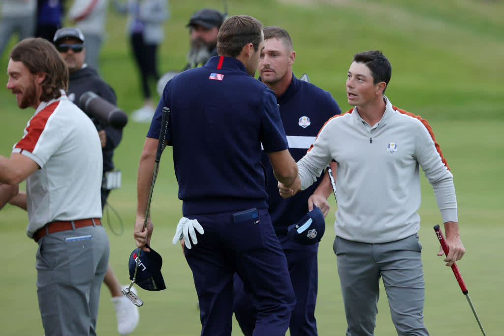 KOHLER, WISCONSIN - SEPTEMBER 25: Scottie Scheffler of team United States and Bryson DeChambeau of team United States shake hands with Tommy Fleetwood of England and team Europe and Viktor Hovland of Norway and team Europe after defeating them 3&1 during Saturday Morning Foursome Matches of the 43rd Ryder Cup at Whistling Straits on September 25, 2021 in Kohler, Wisconsin. (Photo by Stacy Revere/Getty Images)