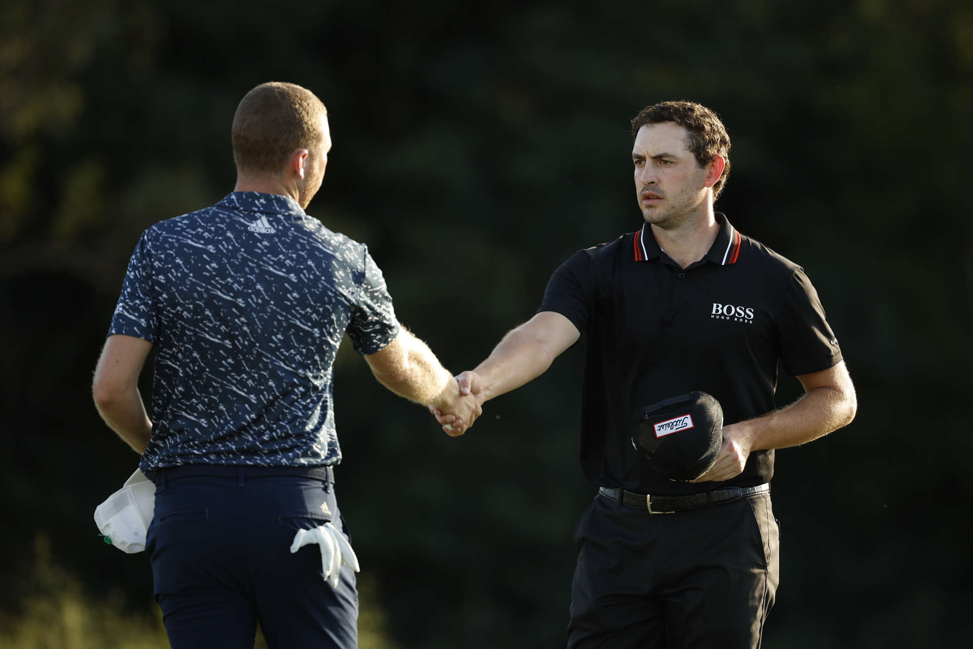 LAHAINA, HAWAII - JANUARY 08: (L-R) Daniel Berger of the United States and Patrick Cantlay of the United States shake hands on the 18th green during the third round of the Sentry Tournament of Champions at the Plantation Course at Kapalua Golf Club on January 08, 2022 in Lahaina, Hawaii. (Photo by Cliff Hawkins/Getty Images)
