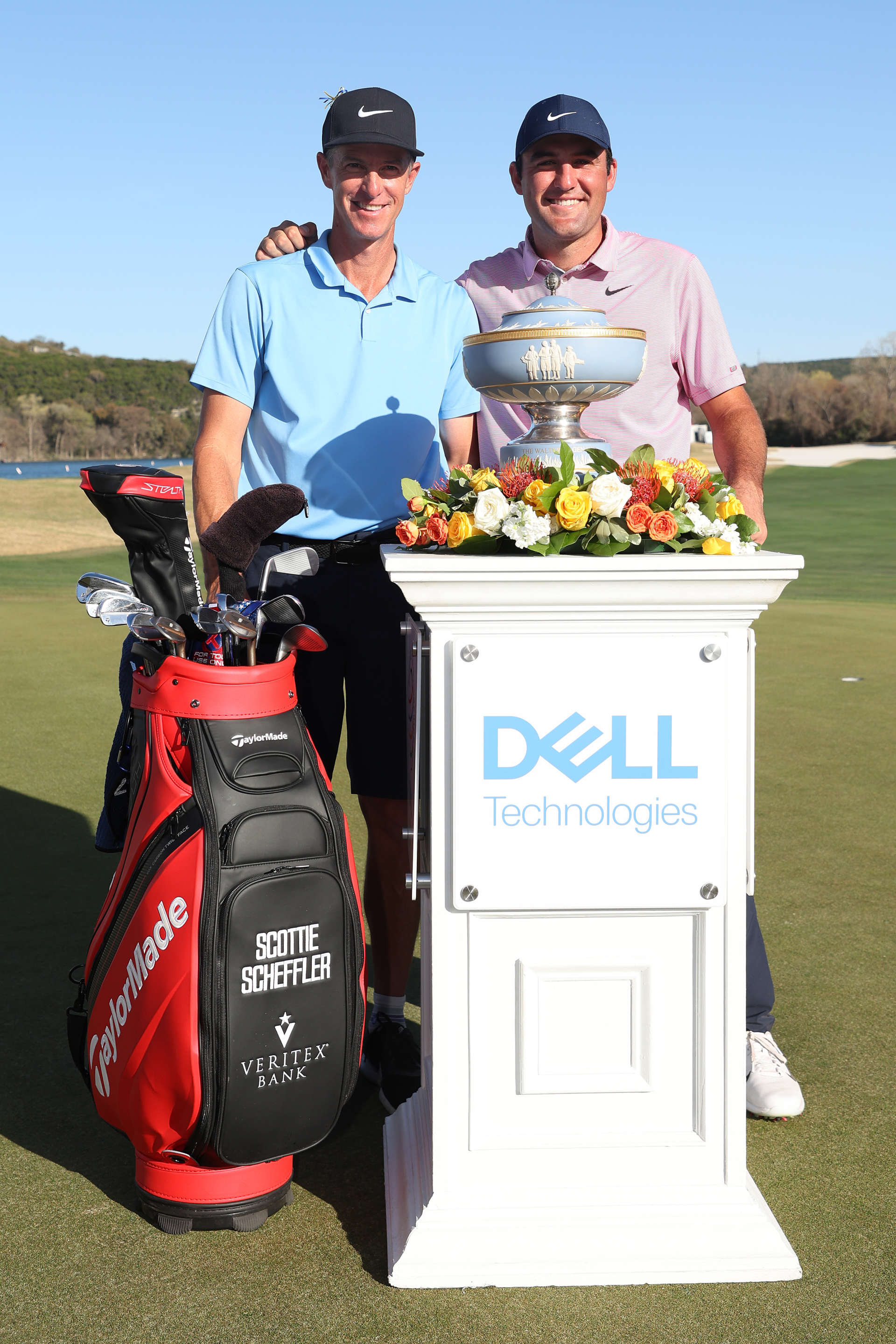 AUSTIN, TEXAS - MARCH 27: Scottie Scheffler of the United States poses with his caddie Ted Scott and the Walter Hagen Cup after defeating Kevin Kisner of the United States (not pictured) 4&3 in thier finals match to win the World Golf Championships-Dell Technologies Match Play at Austin Country Club on March 27, 2022 in Austin, Texas. (Photo by Gregory Shamus/Getty Images)
