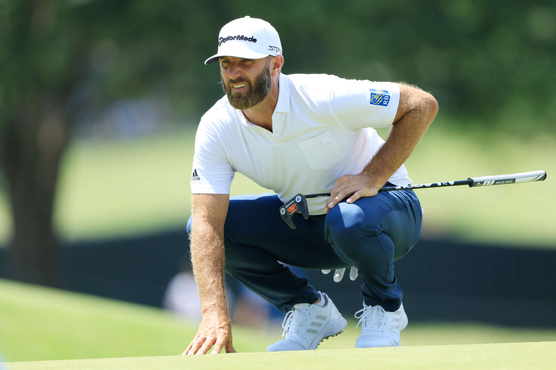 TULSA, OKLAHOMA - MAY 19: Dustin Johnson of the United States lines up a putt on the fourth green during the first round of the 2022 PGA Championship at Southern Hills Country Club on May 19, 2022 in Tulsa, Oklahoma. (Photo by Sam Greenwood/Getty Images)