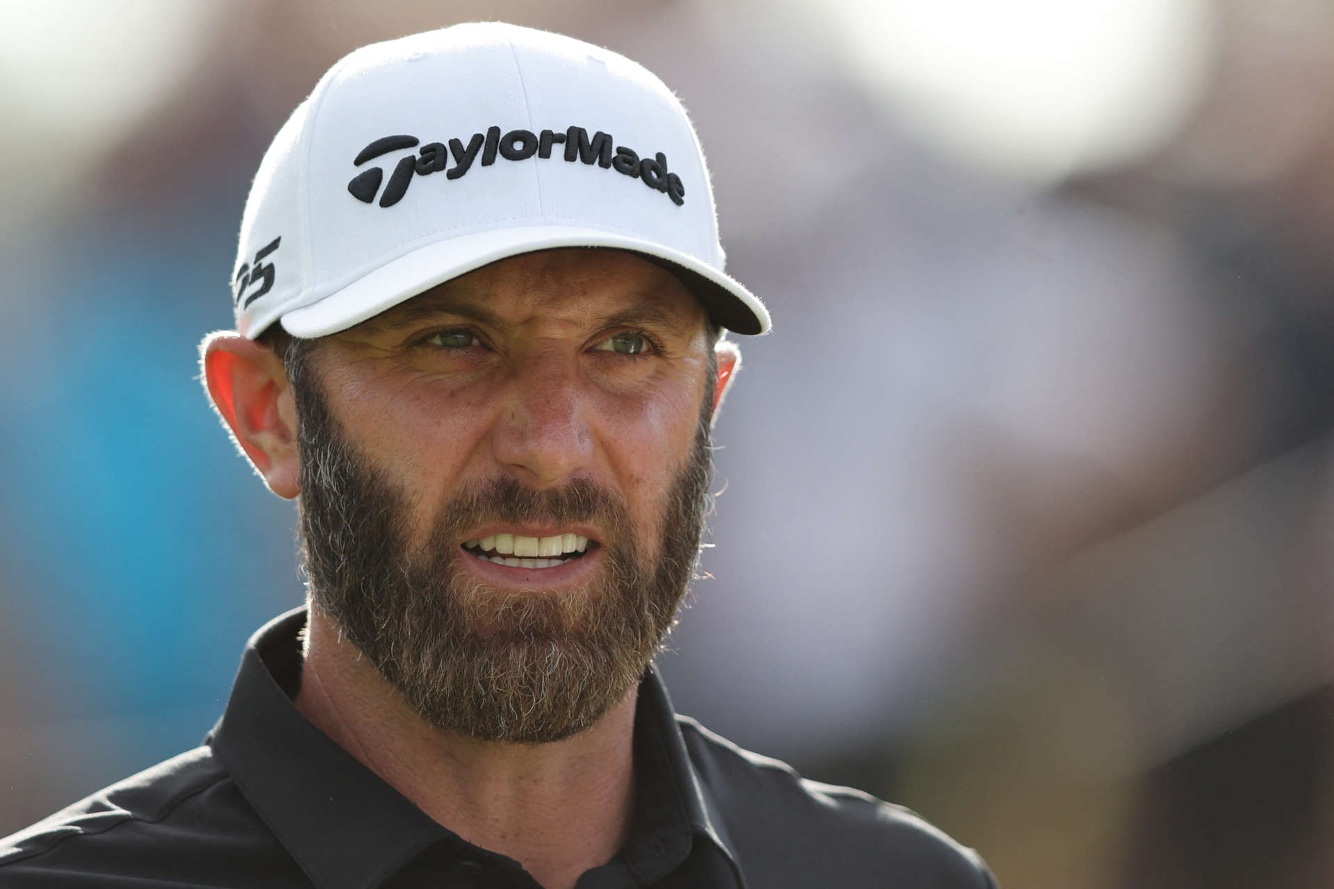 US golfer Dustin Johnson reacts as he prepares to play a shot on the 16th hole on the third and final day of the LIV Golf Invitational Series event at The Centurion Club in St Albans, north of London, on June 11, 2022. - The LIV Golf Invitational London, the launch event of a lucrative and divisive series that is rocking the sport reaches it's conclusion. The $25 million event in St Albans -- the biggest prize pot in history -- is the first of eight tournaments this year bankrolled by Saudi Arabia's sovereign wealth fund, worth a combined $255 million. (Photo by Adrian DENNIS / AFP) (Photo by ADRIAN DENNIS/AFP via Getty Images)