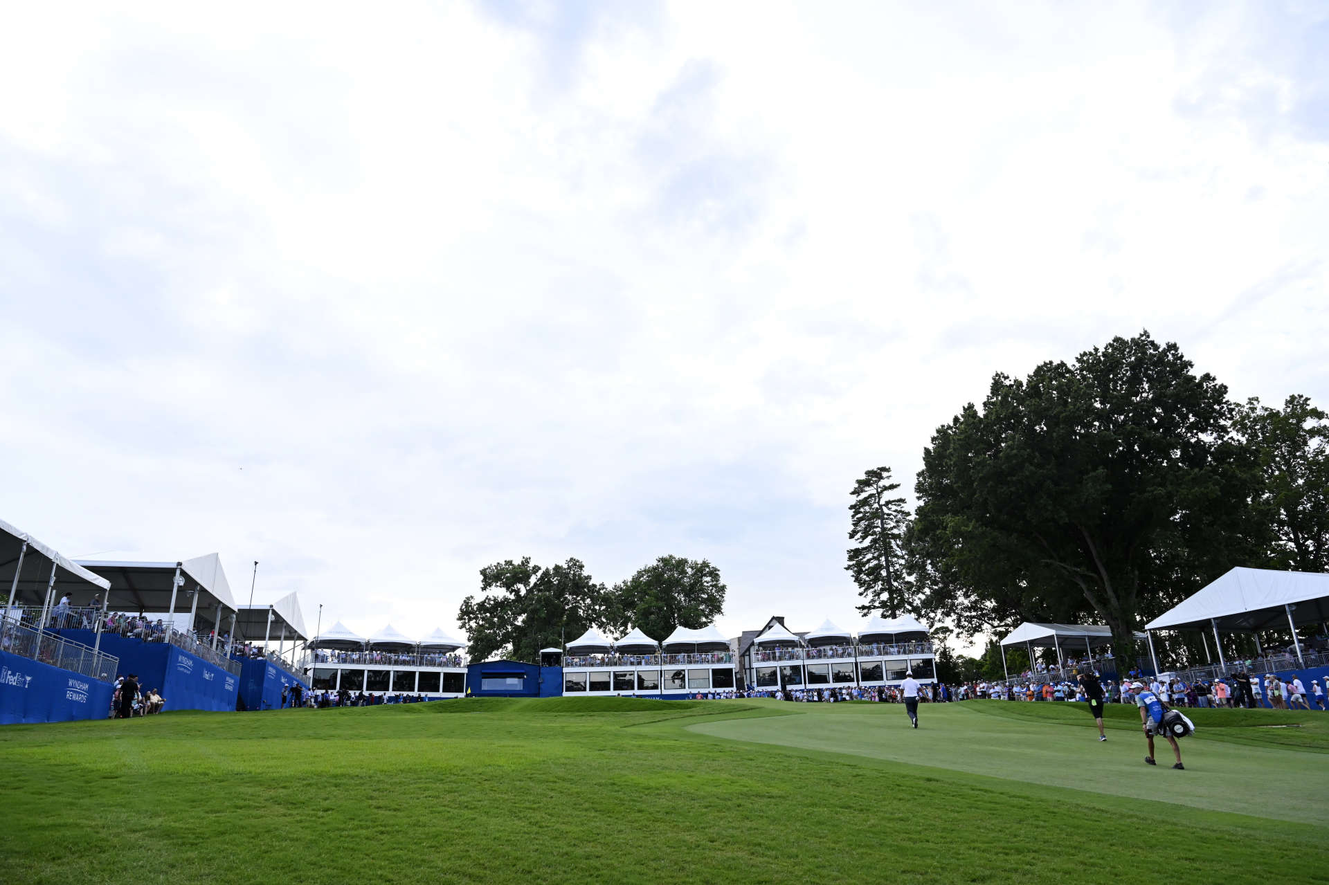 GREENSBORO, NORTH CAROLINA - AUGUST 07: Joohyung Kim of Korea walks on the 18th green during the final round of the Wyndham Championship at Sedgefield Country Club on August 07, 2022 in Greensboro, North Carolina. (Photo by Eakin Howard/Getty Images)