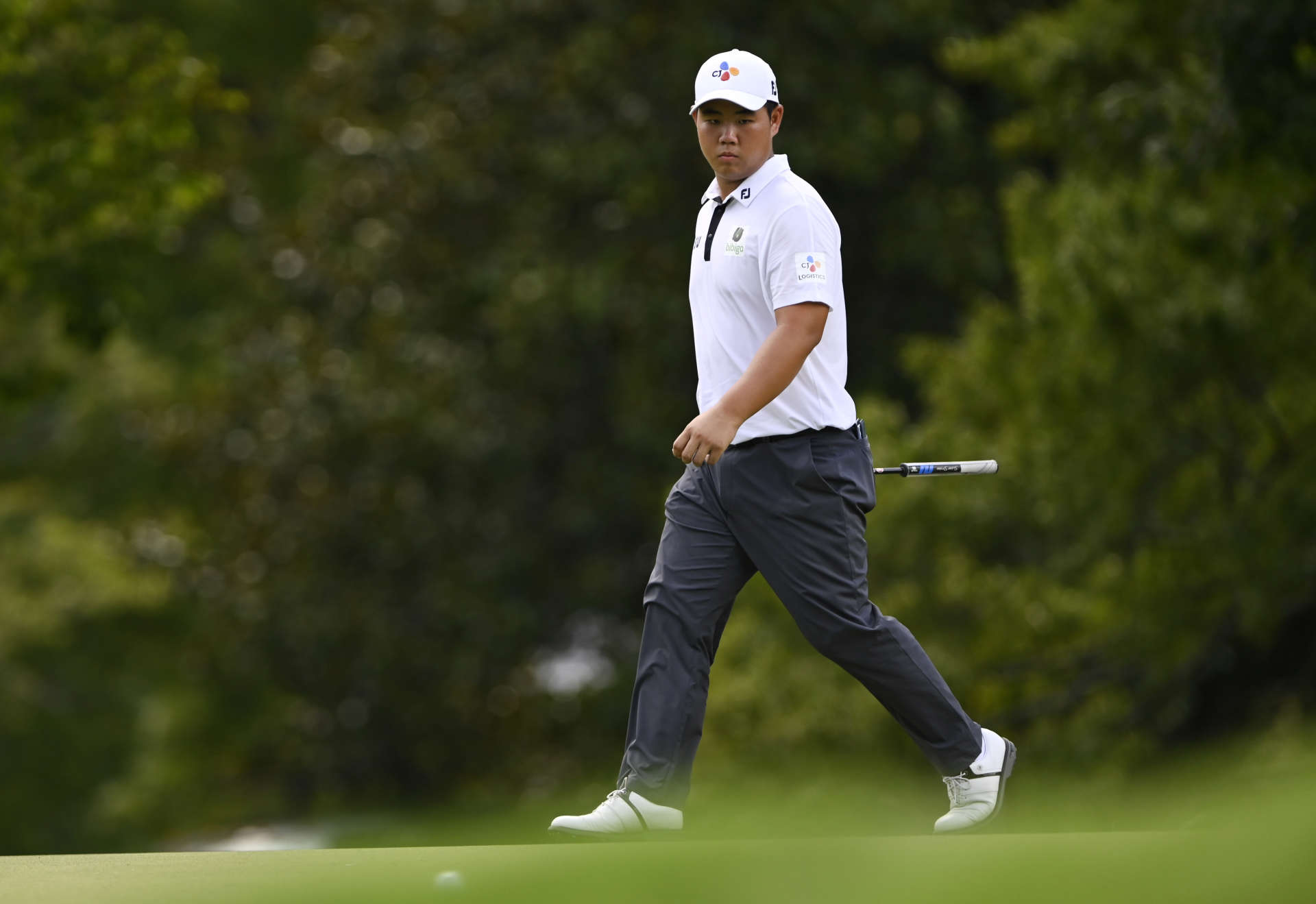 GREENSBORO, NORTH CAROLINA - AUGUST 07: Joohyung Kim of Korea walks on the 14th green during the final round of the Wyndham Championship at Sedgefield Country Club on August 07, 2022 in Greensboro, North Carolina. (Photo by Eakin Howard/Getty Images)
