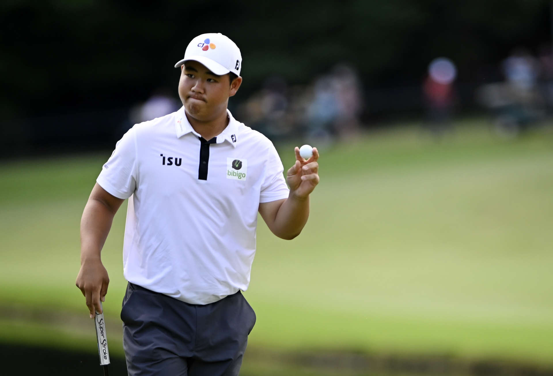 GREENSBORO, NORTH CAROLINA - AUGUST 07: Joohyung Kim of Korea reacts to a birdie putt on the 16th green during the final round of the Wyndham Championship at Sedgefield Country Club on August 07, 2022 in Greensboro, North Carolina. (Photo by Eakin Howard/Getty Images)
