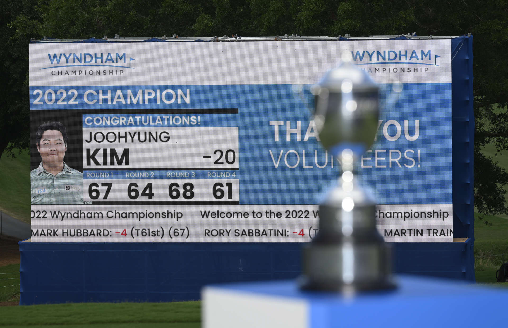 GREENSBORO, NORTH CAROLINA - AUGUST 07: The trophy and scoreboard are seen on the 18th hole during the final round of the Wyndham Championship at Sedgefield Country Club on August 07, 2022 in Greensboro, North Carolina. (Photo by Eakin Howard/Getty Images)