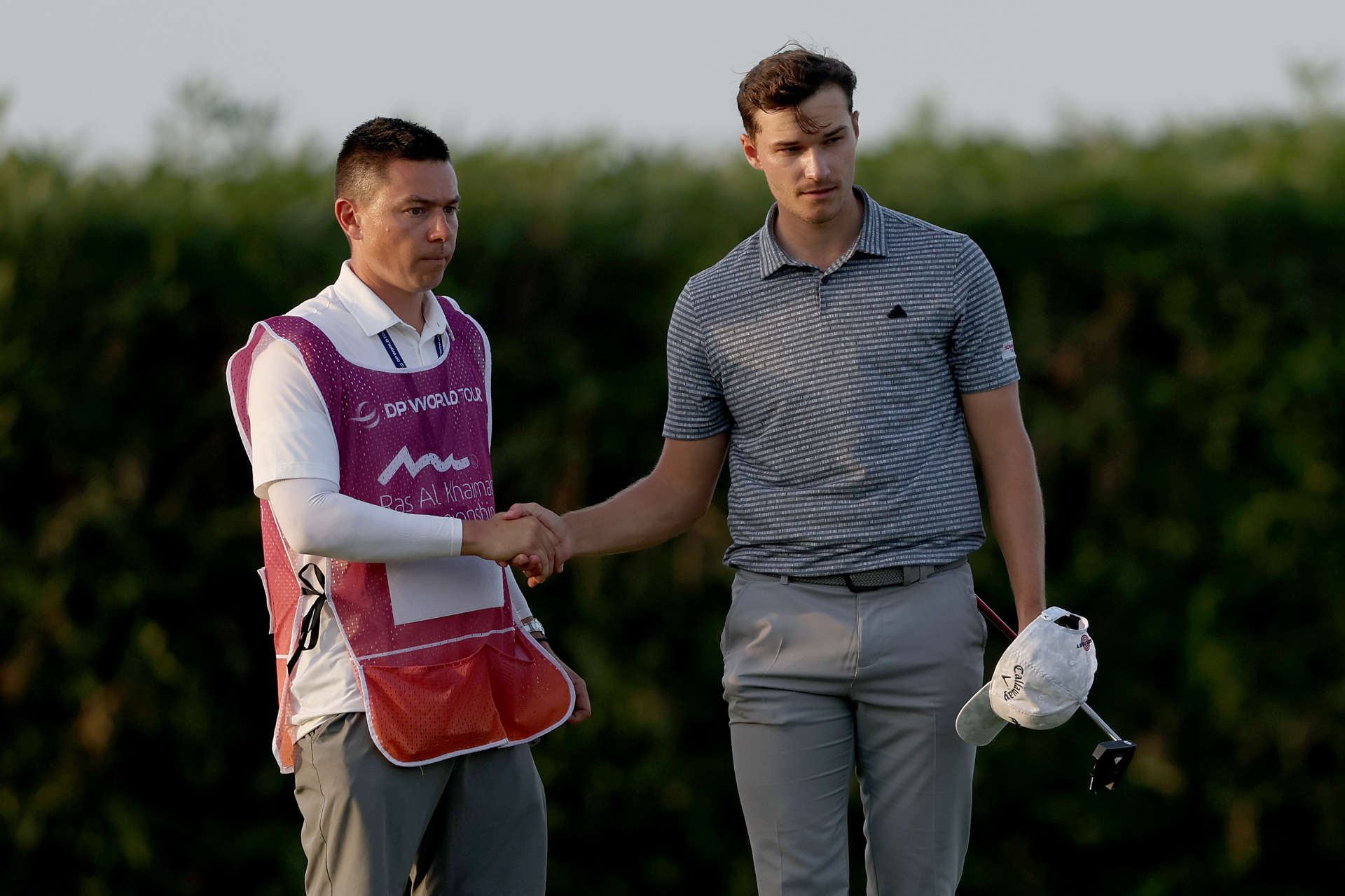 RAS AL KHAIMAH, UNITED ARAB EMIRATES - FEBRUARY 03: Rasmus Hojgaard of Denmark shake hands after finishing their rounfd on the 18th Hole with his caddie on Day Two of the Ras Al Khaimah Championship at Al Hamra Golf Club on February 03, 2023 in Ras al Khaimah, United Arab Emirates. (Photo by Warren Little/Getty Images)