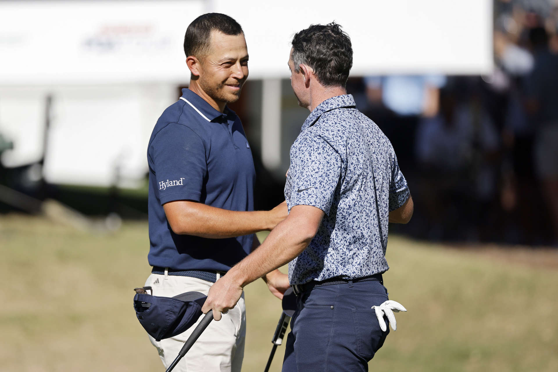 AUSTIN, TEXAS - MARCH 25: Xander Schauffele of the United States (L) and Rory McIlroy of Northern Ireland shake hands on the 18th green after McIlroy won their match 1 up during day four of the World Golf Championships-Dell Technologies Match Play at Austin Country Club on March 25, 2023 in Austin, Texas. (Photo by Mike Mulholland/Getty Images)