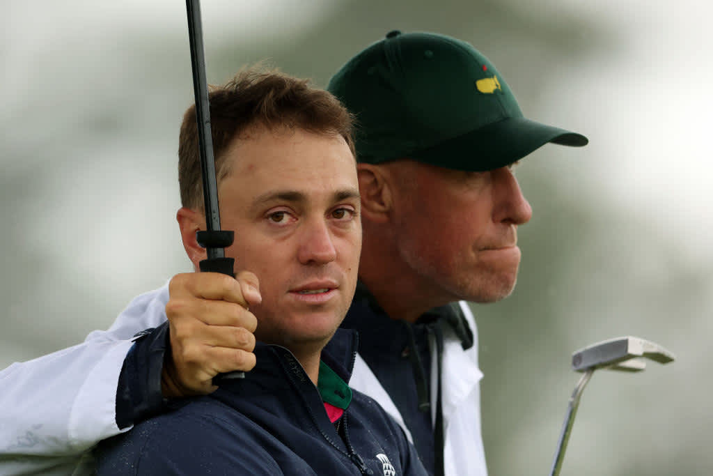 AUGUSTA, GEORGIA - APRIL 08: Justin Thomas of the United States and his caddie Jim 'Bones' Mackay react to his bogey on the 18th green during the continuation of the weather delayed second round of the 2023 Masters Tournament at Augusta National Golf Club on April 08, 2023 in Augusta, Georgia. (Photo by Christian Petersen/Getty Images)