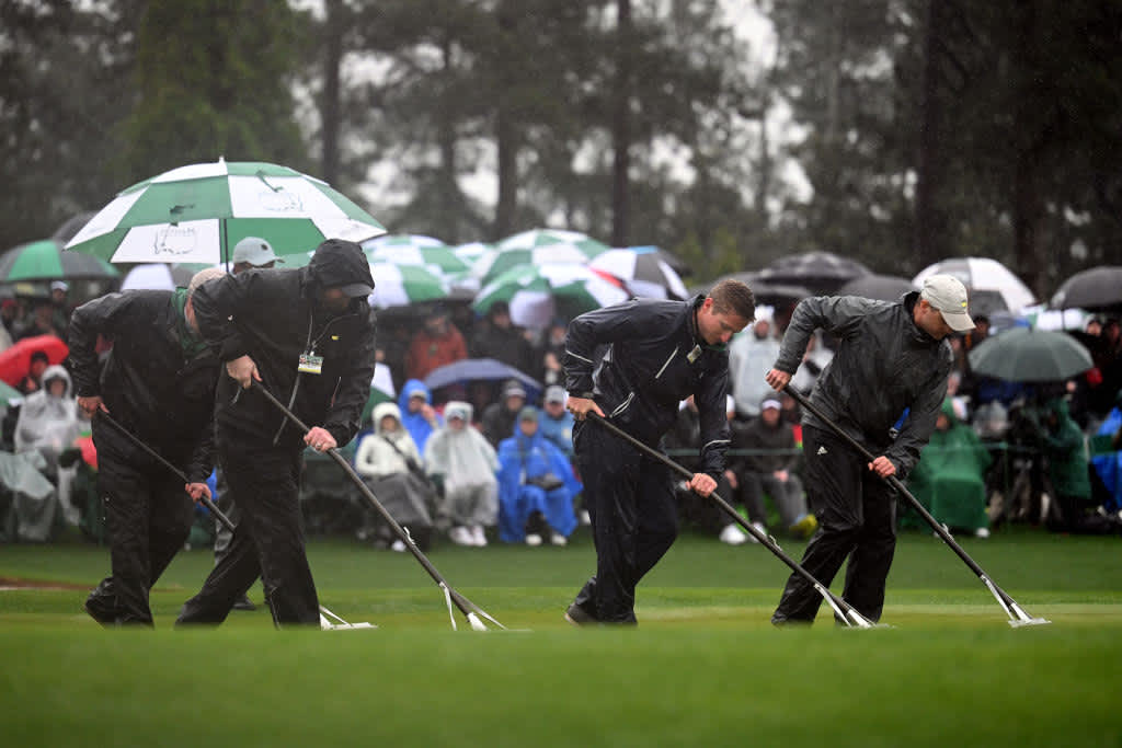 AUGUSTA, GEORGIA - APRIL 08: Greenskeepers remove standing water on the 18th green during the continuation of the weather delayed second round of the 2023 Masters Tournament at Augusta National Golf Club on April 08, 2023 in Augusta, Georgia. (Photo by Ross Kinnaird/Getty Images)