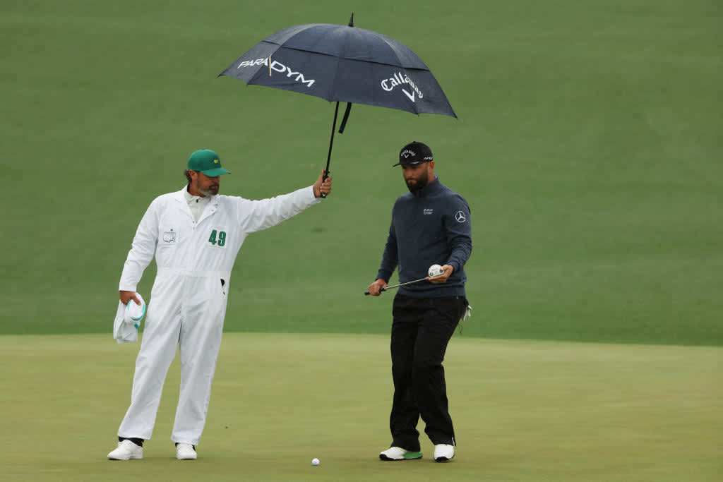 AUGUSTA, GEORGIA - APRIL 08: Jon Rahm of Spain looks over a putt on the second green with his caddie Adam Hayes during the third round of the 2023 Masters Tournament at Augusta National Golf Club on April 08, 2023 in Augusta, Georgia. (Photo by Patrick Smith/Getty Images)