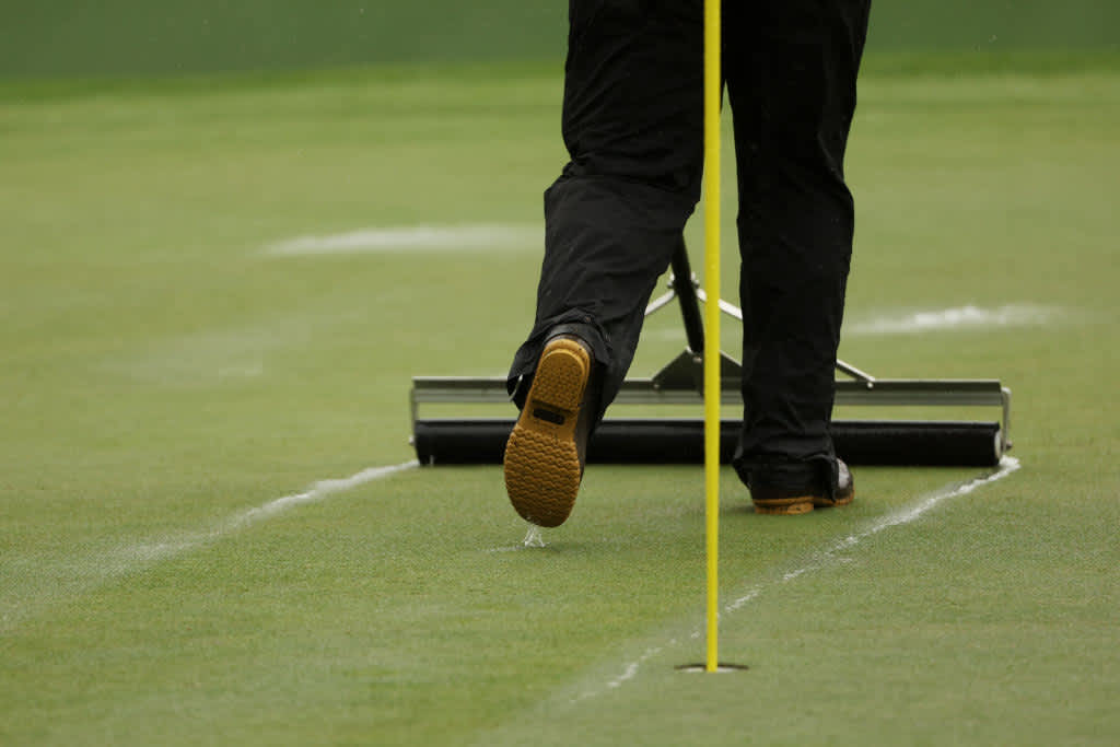 AUGUSTA, GEORGIA - APRIL 08: A greenskeeper clears water from the seventh green during the third round of the 2023 Masters Tournament at Augusta National Golf Club on April 08, 2023 in Augusta, Georgia. (Photo by Patrick Smith/Getty Images)