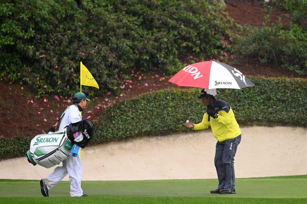 AUGUSTA, GEORGIA - APRIL 08: Hideki Matsuyama of Japan talks with his caddie Shota Hayafuji after play was suspended due to weather conditions during the third round of the 2023 Masters Tournament at Augusta National Golf Club on April 08, 2023 in Augusta, Georgia. (Photo by Ross Kinnaird/Getty Images)
