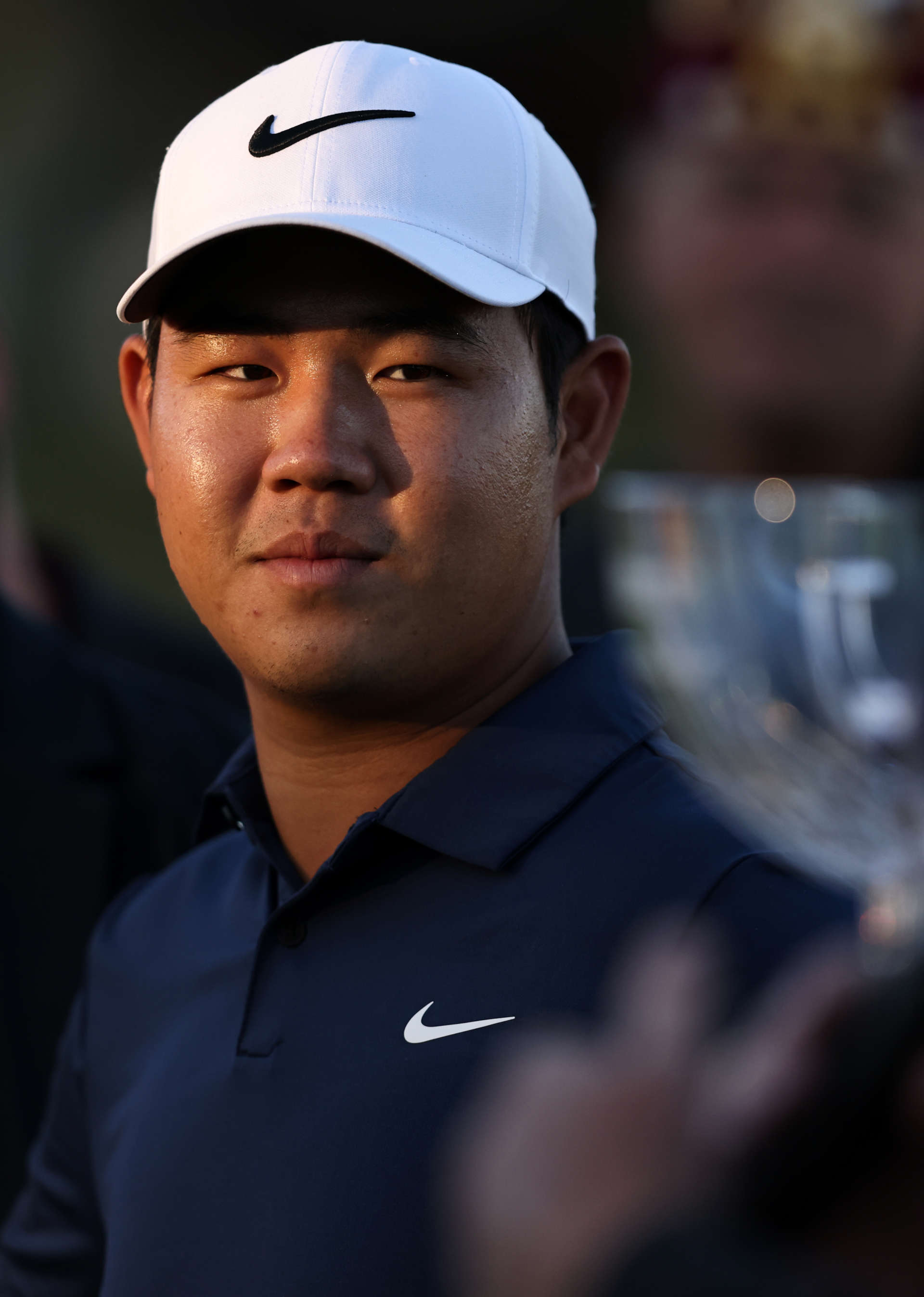 LAS VEGAS, NEVADA - OCTOBER 15: Tom Kim of South Korea walks onto the 18th green for the trophy presentation after putting in to winduring the final round of the Shriners Children's Open at TPC Summerlin on October 15, 2023 in Las Vegas, Nevada. (Photo by Michael Owens/Getty Images)