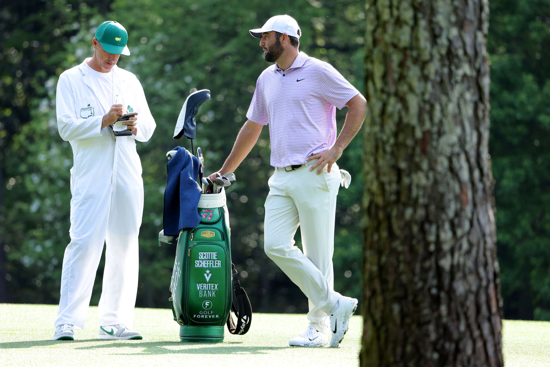 AUGUSTA, GEORGIA - APRIL 10: Scottie Scheffler of the United States and his caddie, Ted Scott, look on from the 11th hole during a practice round prior to the 2024 Masters Tournament at Augusta National Golf Club on April 10, 2024 in Augusta, Georgia. (Photo by Jamie Squire/Getty Images) (Photo by Jamie Squire/Getty Images)