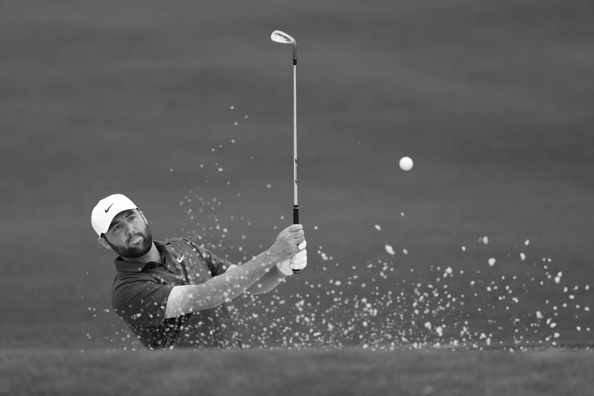 AUGUSTA, GEORGIA - APRIL 09: (EDITOR'S NOTE:This image has been converted to black and white.) Scottie Scheffler of the United States hits his shot from the second tee during a practice round prior to the 2024 Masters Tournament at Augusta National Golf Club on April 09, 2024 in Augusta, Georgia. (Photo by Maddie Meyer/Getty Images)