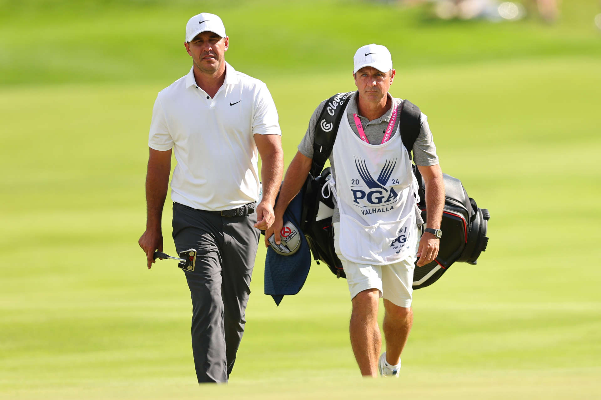 LOUISVILLE, KENTUCKY - MAY 18: Brooks Koepka of the United States walks with his caddie Ricky Elliott during the third round of the 2024 PGA Championship at Valhalla Golf Club on May 18, 2024 in Louisville, Kentucky. (Photo by Michael Reaves/Getty Images)