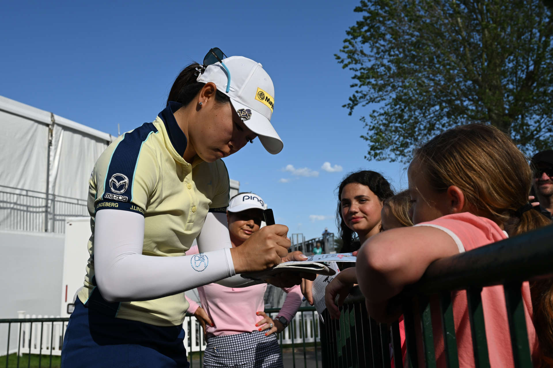 GALLOWAY, NEW JERSEY - JUNE 07: Kelly Tan of Malaysia signs autographs near the 18th green during the first round of the ShopRite LPGA Classic Presented by Acer at Seaview Bay Course on June 07, 2024 in Galloway, New Jersey. (Photo by Drew Hallowell/Getty Images)