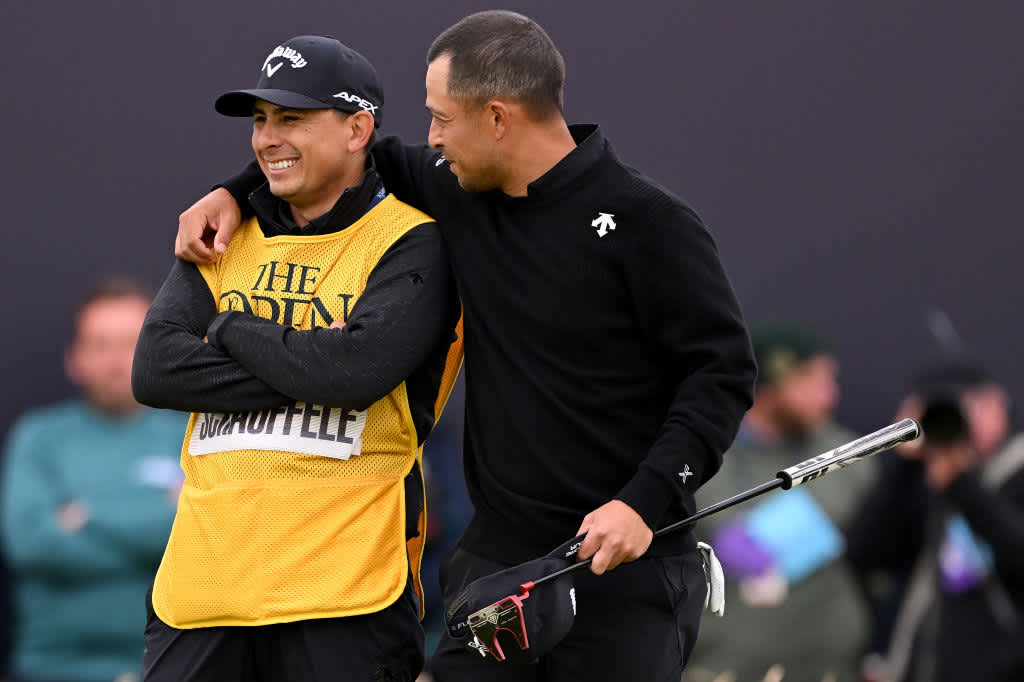 TROON, SCOTLAND - JULY 21: Xander Schauffele of the United States celebrates with his caddie Austin Kaiser on the 18th green during day four of The 152nd Open championship at Royal Troon on July 21, 2024 in Troon, Scotland. (Photo by Ross Kinnaird/Getty Images)