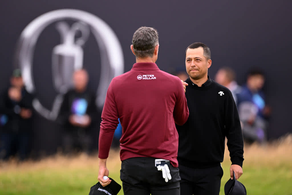 TROON, SCOTLAND - JULY 21: Xander Schauffele of the United States shakes hands with Justin Rose of England on the 18th green during day four of The 152nd Open championship at Royal Troon on July 21, 2024 in Troon, Scotland. (Photo by Ross Kinnaird/Getty Images)