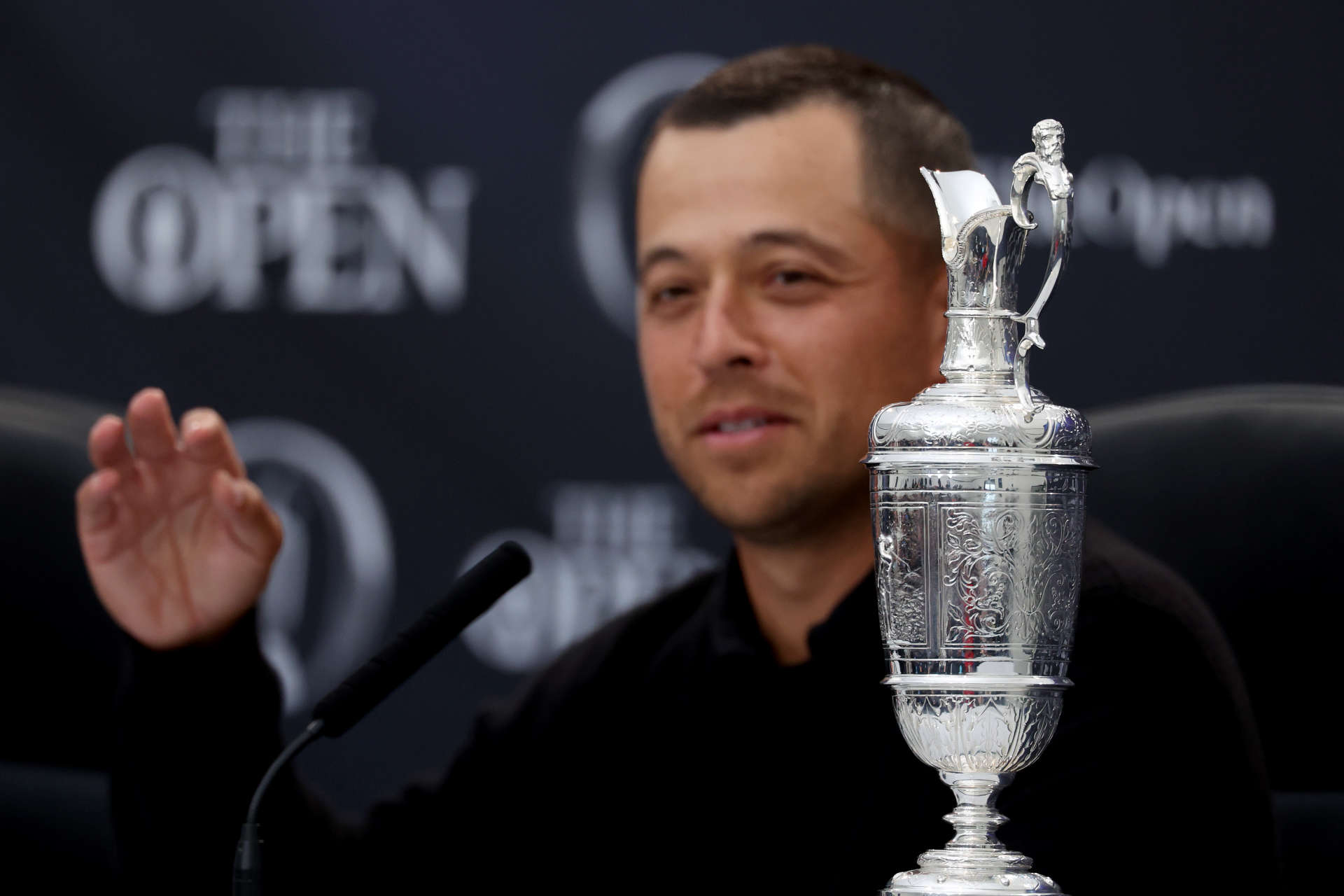 TROON, SCOTLAND - JULY 21: A detailed view of the Claret Jug as Xander Schauffele of the United States talks to the media in a press conference after winning the Claret Jug during day four of The 152nd Open championship at Royal Troon on July 21, 2024 in Troon, Scotland. (Photo by Kevin C. Cox/Getty Images)
