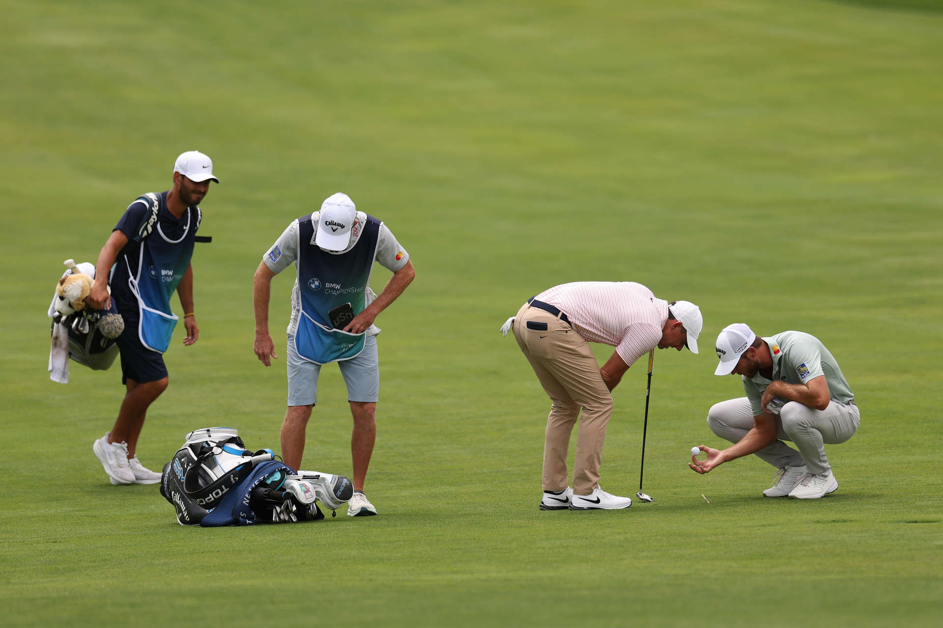 CASTLE ROCK, COLORADO - AUGUST 24: Sam Burns of the United States looks at his ball with Rory McIlroy of Northern Ireland on the ninth hole during the third round of the BMW Championship at Castle Pines Golf Club on August 24, 2024 in Castle Rock, Colorado. (Photo by Harry How/Getty Images)