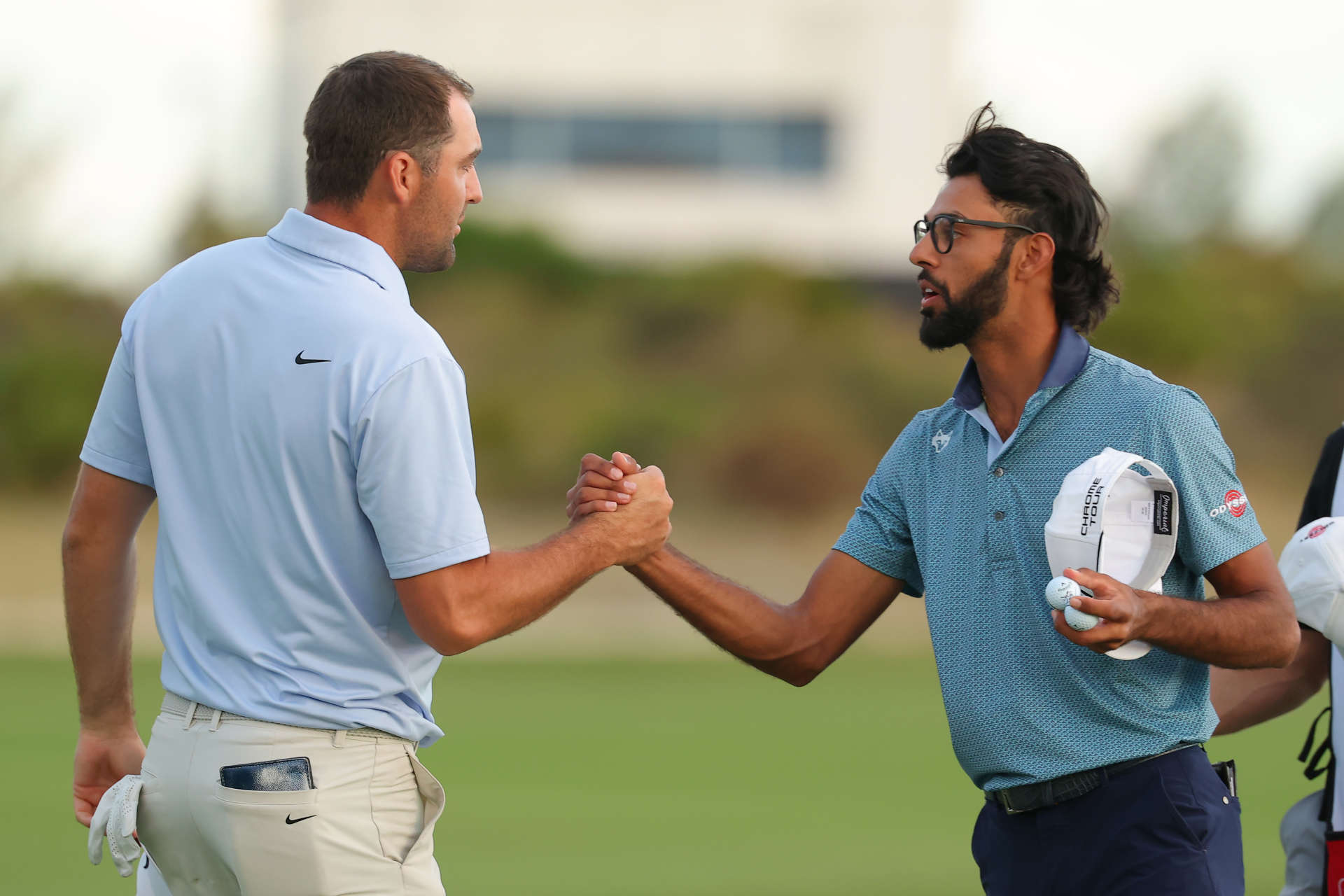 NASSAU, BAHAMAS - DECEMBER 07: Scottie Scheffler of the United States and Akshay Bhatia of the United States embrace on the 18th green during the third round of the Hero World Challenge 2024 at Albany Golf Course on December 07, 2024 in Nassau, Bahamas. (Photo by Kevin C. Cox/Getty Images)