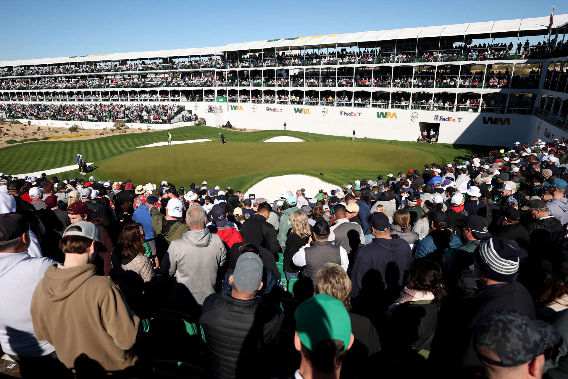 SCOTTSDALE, ARIZONA - FEBRUARY 11: A general view is seen as Kurt Kitayama of the United States putts on the 16th green during the continuation of the third round of the WM Phoenix Open at TPC Scottsdale on February 11, 2024 in Scottsdale, Arizona. (Photo by Christian Petersen/Getty Images)