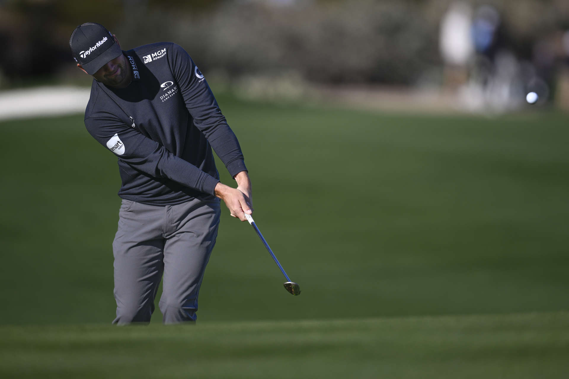 SCOTTSDALE, ARIZONA - FEBRUARY 11: Taylor Montgomery of the United States chips to the 17th green during the continuation of the third round of the WM Phoenix Open at TPC Scottsdale on February 11, 2024 in Scottsdale, Arizona. (Photo by Orlando Ramirez/Getty Images)