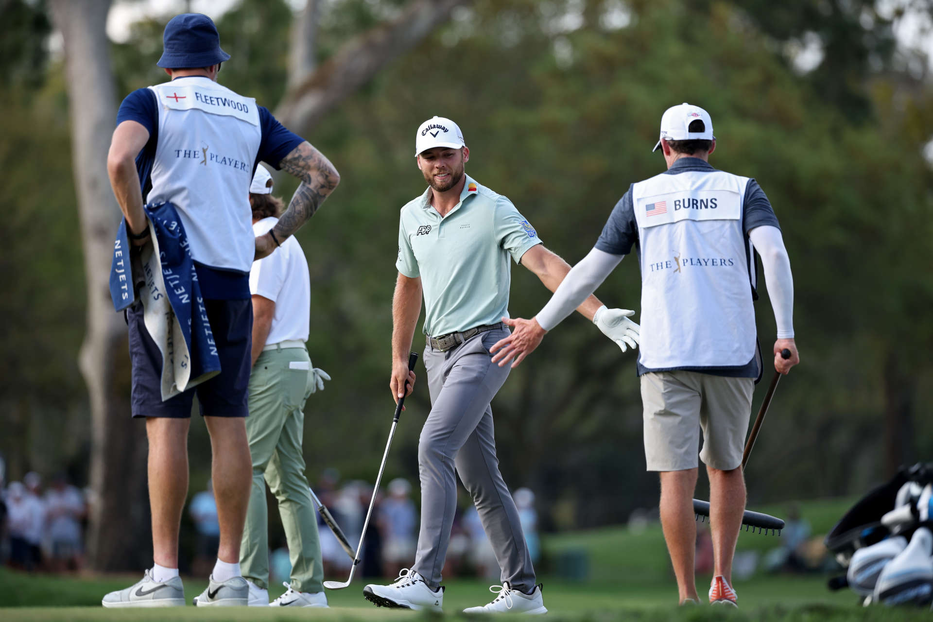 PONTE VEDRA BEACH, FLORIDA - MARCH 15: Sam Burns of the United States celebrates a shot with his caddie on the 14th green during the second round of THE PLAYERS Championship on the Stadium Course at TPC Sawgrass on March 15, 2024 in Ponte Vedra Beach, Florida. (Photo by Jared C. Tilton/Getty Images)