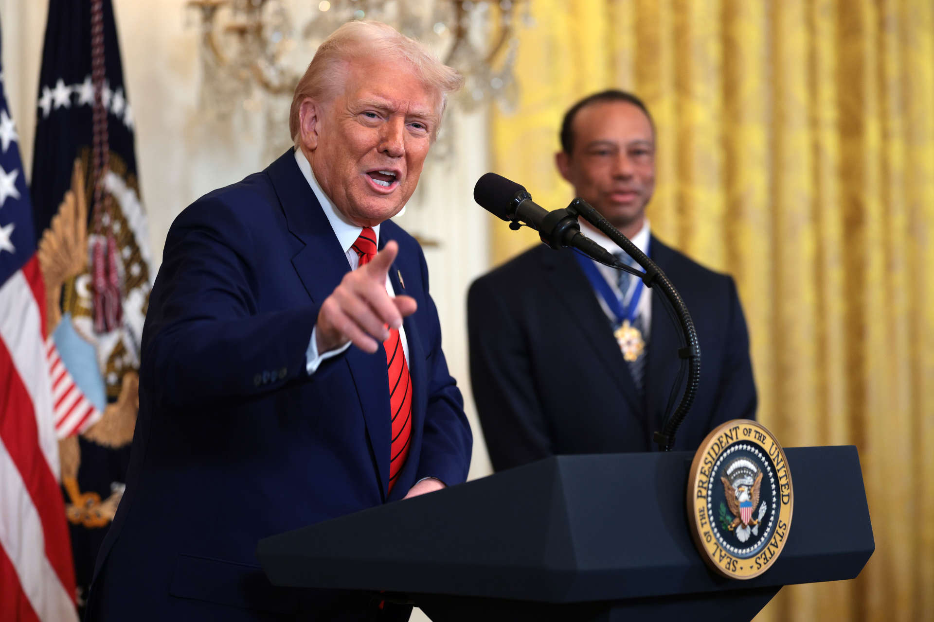 WASHINGTON, DC - FEBRUARY 20: U.S. President Donald Trump, joined by golf legend Tiger Woods, speaks during a reception honoring Black History Month in the East Room of the White House on February 20, 2025 in Washington, DC. The Black History Month celebration comes as Trump has signed a series of executive orders ending federal diversity, equity and inclusion (DEI) programs and cutting funding to schools and Universities that do not cut DEI programs. (Photo by Win McNamee/Getty Images)