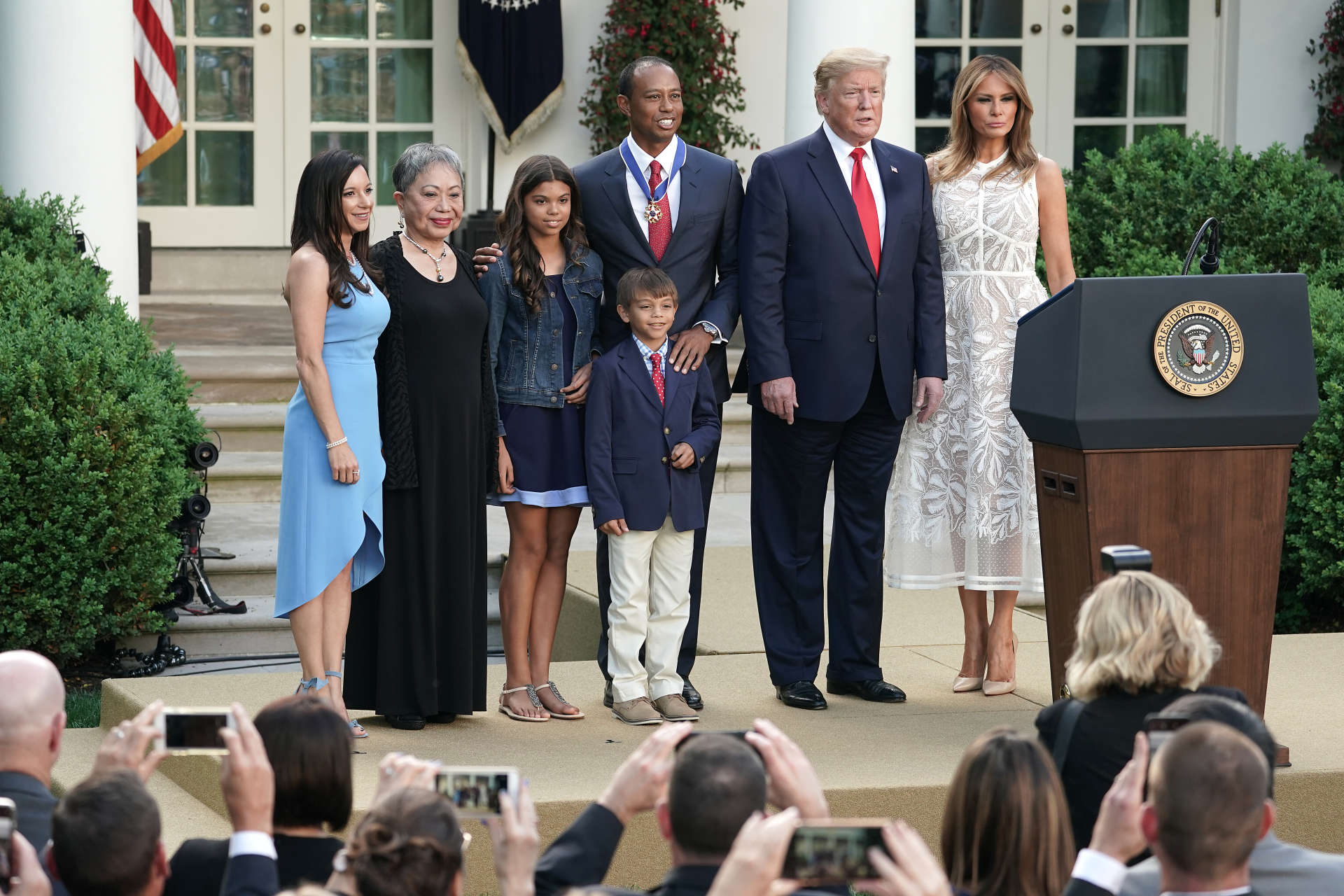 WASHINGTON, DC - MAY 06: (L-R) Erica Herman, Kultida Woods, Sam Alexis Woods, Charlie Axel Woods, Tiger Woods, U.S. President Donald Trump and first lady Melania Trump pose for photographs after Tiger Woods was presented with the Medal of Freedom during a ceremony in the Rose Garden at the White House May 06, 2019 in Washington, DC. Trump announced he would give the nation’s highest civilian honor to business partner Woods, 43, in honor of his Masters victory last month. (Photo by Chip Somodevilla/Getty Images)