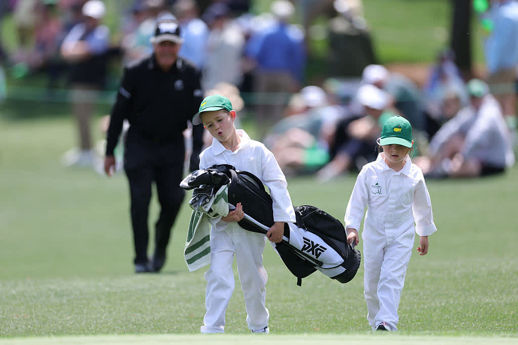 AUGUSTA, GEORGIA - APRIL 09: Family members of Gary Player of South Africa carry his golf bag on the second hole during the Par Three Contest prior to the 2025 Masters Tournament at Augusta National Golf Club on April 09, 2025 in Augusta, Georgia. (Photo by Andrew Redington/Getty Images)