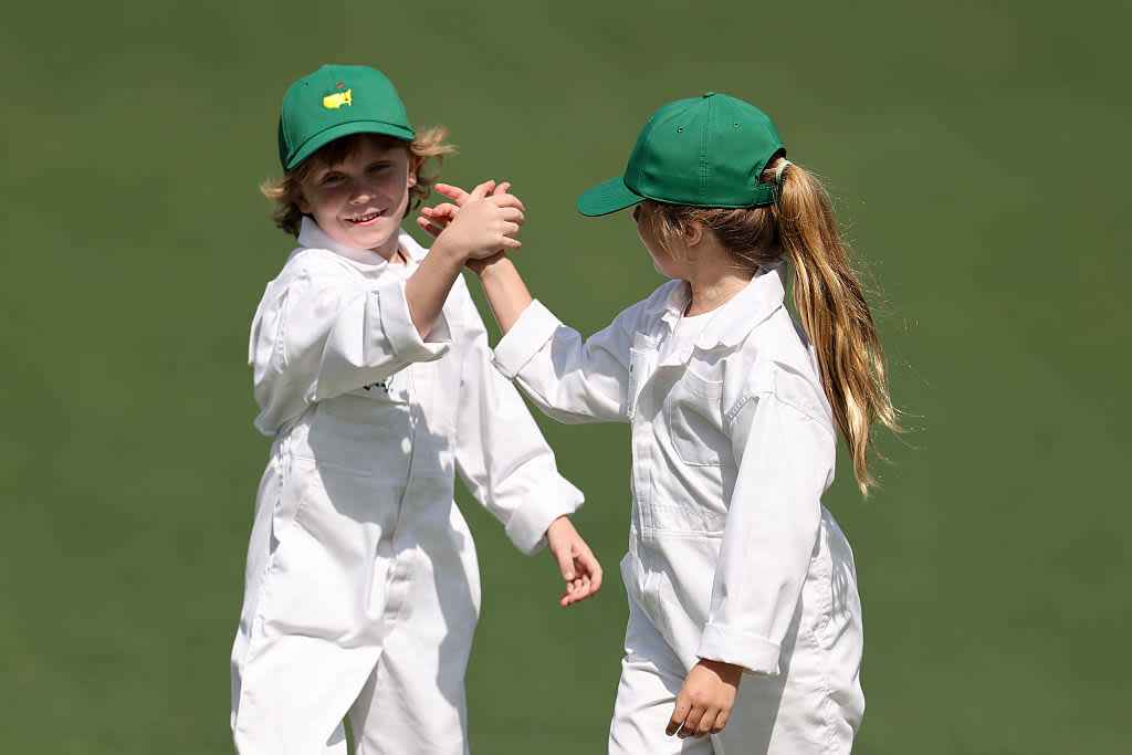 AUGUSTA, GEORGIA - APRIL 09: Son of Tommy Fleetwood of England, Franklin Fleetwood and daughter of Shane Lowry of Ireland, Iris Lowry, shake hands on the seventh hole during the Par Three Contest prior to the 2025 Masters Tournament at Augusta National Golf Club on April 09, 2025 in Augusta, Georgia. (Photo by Michael Reaves/Getty Images)