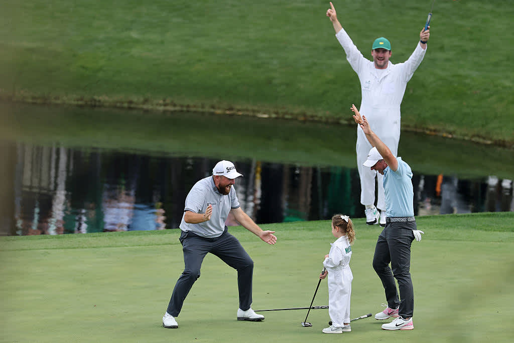 AUGUSTA, GEORGIA - APRIL 09: Rory McIlroy of Northern Ireland 
celebrates a putt by his daughter, Poppy McIlroy, alongside Shane Lowry of Ireland on the ninth green during the Par Three Contest prior to the 2025 Masters Tournament at Augusta National Golf Club on April 09, 2025 in Augusta, Georgia. (Photo by Michael Reaves/Getty Images)