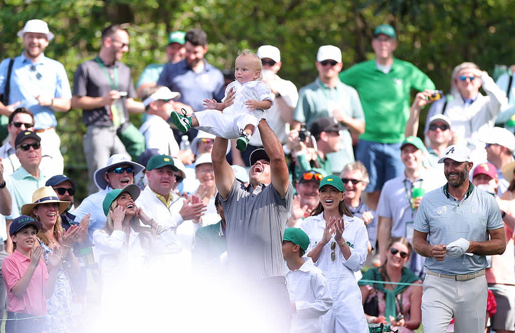 AUGUSTA, GEORGIA - APRIL 09: Brooks Koepka of the United States celebrates with his son, Crew Sims Koepka, following a hole in one on the sixth hole during the Par Three Contest prior to the 2025 Masters Tournament at Augusta National Golf Club on April 09, 2025 in Augusta, Georgia. (Photo by Andrew Redington/Getty Images)