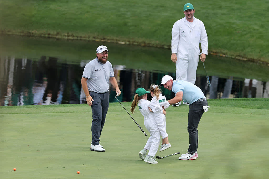 AUGUSTA, GEORGIA - APRIL 09: Rory McIlroy of Northern Ireland 
celebrates a putt by his daughter, Poppy McIlroy, alongside Shane Lowry of Ireland on the ninth green during the Par Three Contest prior to the 2025 Masters Tournament at Augusta National Golf Club on April 09, 2025 in Augusta, Georgia. (Photo by Michael Reaves/Getty Images)