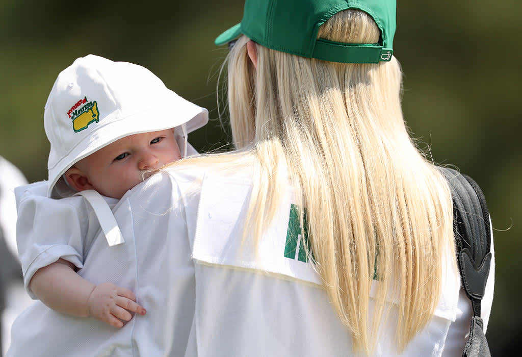 AUGUSTA, GEORGIA - APRIL 09: Kelly Hoge, wife of Tom Hoge of the United States (not pictured), holds their son, Thomas Bennett, during the Par Three Contest prior to the 2025 Masters Tournament at Augusta National Golf Club on April 09, 2025 in Augusta, Georgia. (Photo by Richard Heathcote/Getty Images)